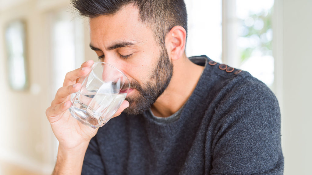 Man drinking water after